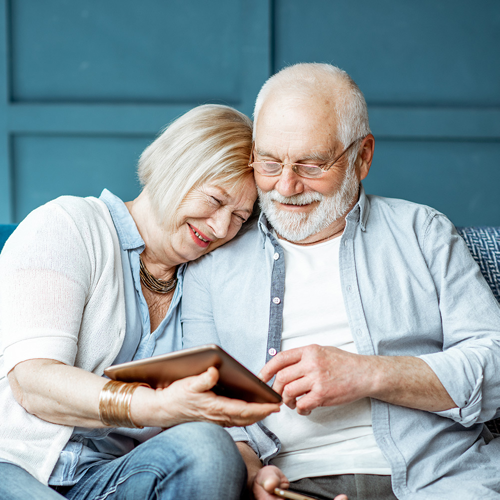 Happy elderly couple sitting together