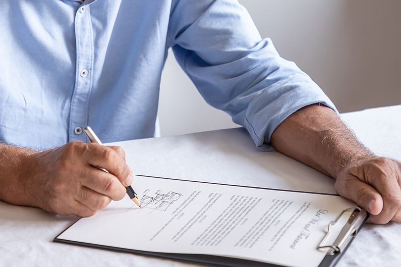 Close up of man signing will