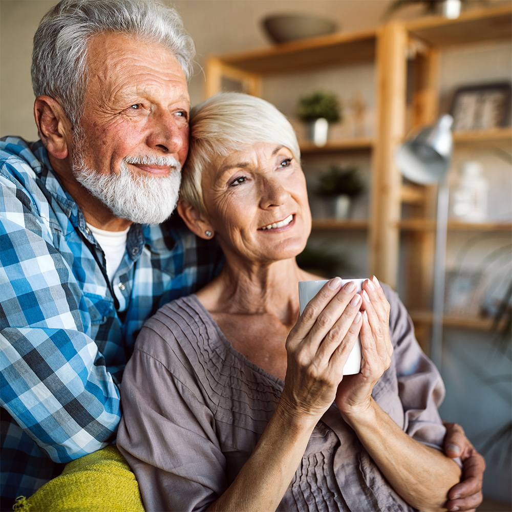 Happy senior couple looking out window